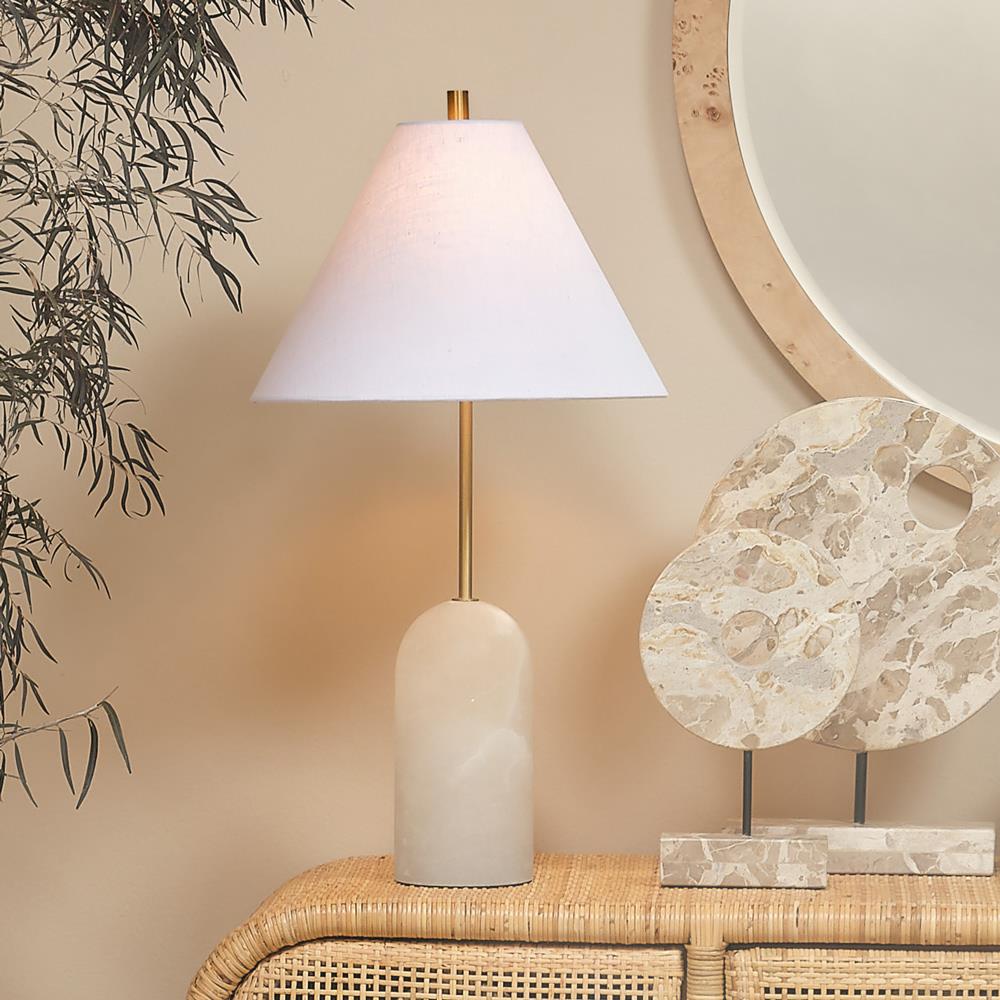 White marble table lamp with conical shade on a rattan console
