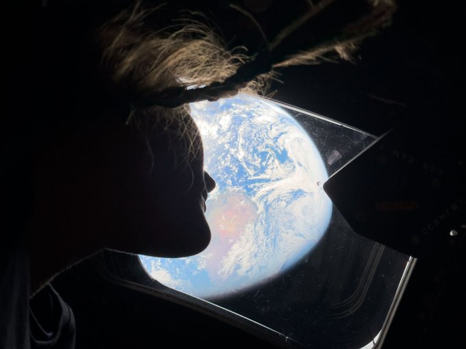 Astronaut silhouette looking at Earth from space